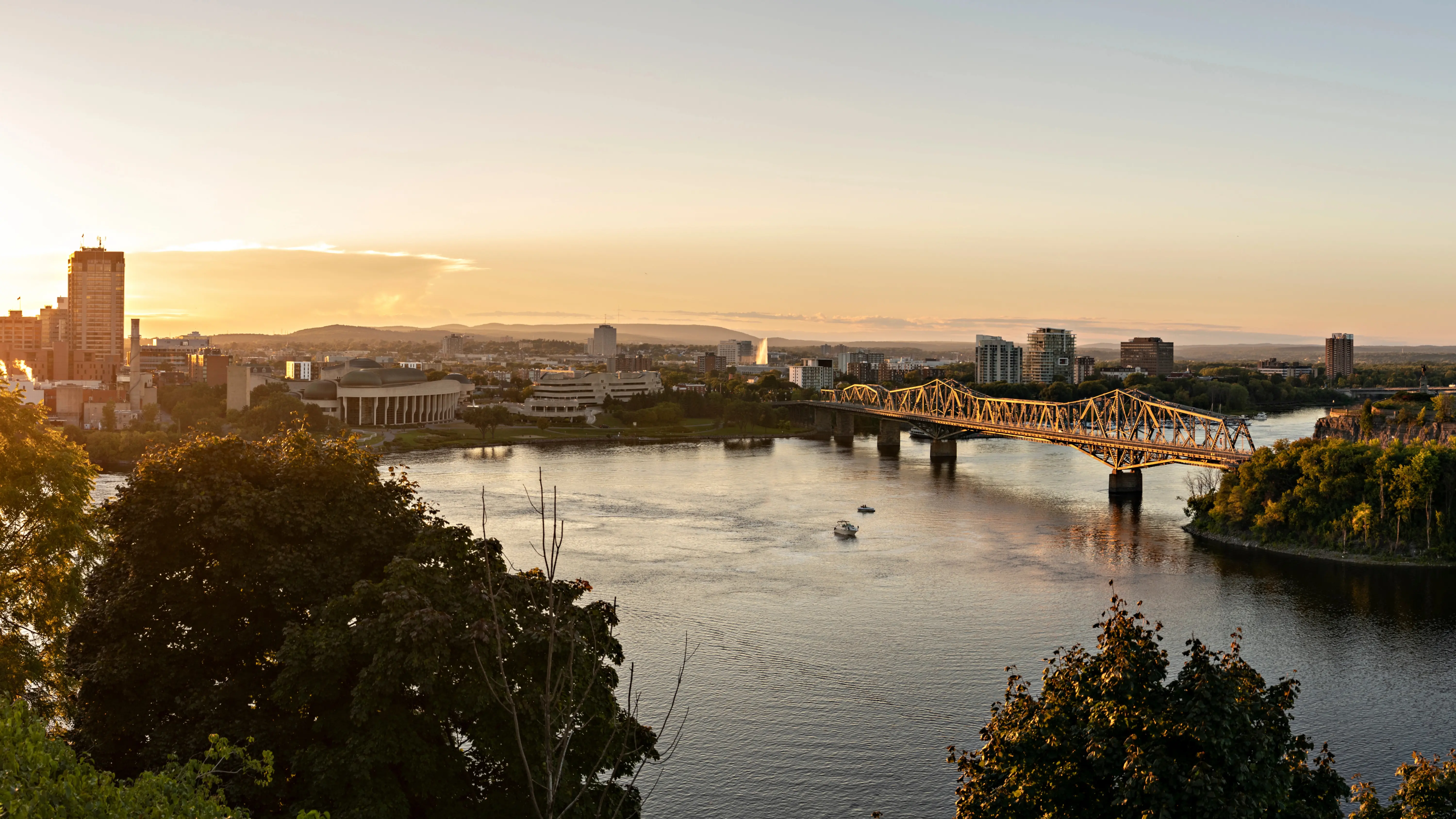 A view of Gloucesters Alexandra Bridge during the day in the fall with the downtown real estate district in the background